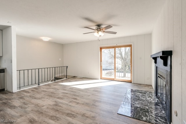 2401 Island Dr Unit 20D, Uniontown, OH 44685 - unfurnished living room with a glass covered fireplace, ceiling fan, and wood finished floors
