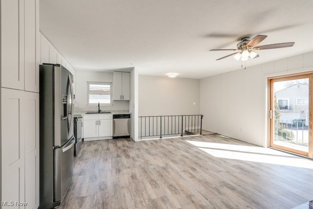 2401 Island Dr Unit 20D, Uniontown, OH 44685 - kitchen featuring appliances with stainless steel finishes, a ceiling fan, light wood-style flooring, light countertops, and open floor plan