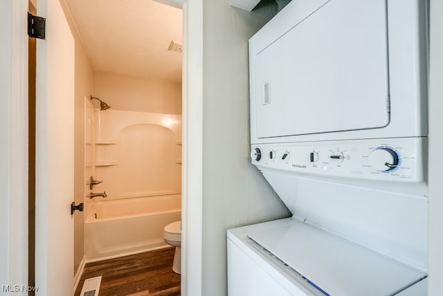 2401 Island Dr Unit 20D, Uniontown, OH 44685 - laundry area with stacked washing machine and dryer and dark wood-style flooring