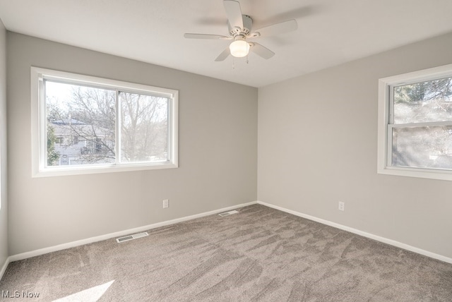 2401 Island Dr Unit 20D, Uniontown, OH 44685 - carpeted empty room with ceiling fan and baseboards