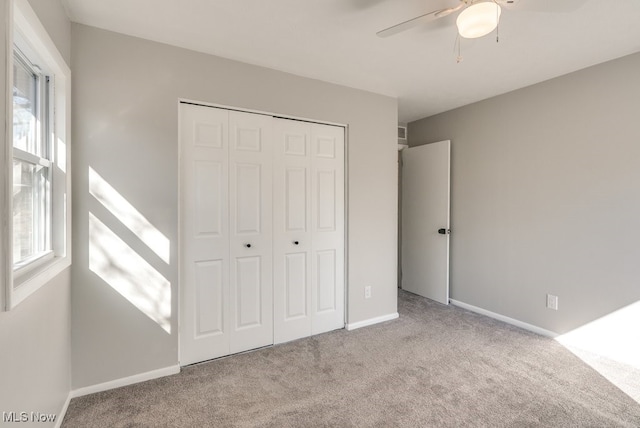 2401 Island Dr Unit 20D, Uniontown, OH 44685 - unfurnished bedroom featuring carpet floors, a closet, and a ceiling fan