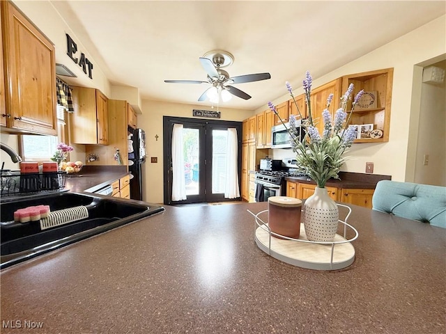 3522 Oakdale Ave, Lorain, OH 44055 - kitchen with appliances with stainless steel finishes, dark countertops, plenty of natural light, and a ceiling fan
