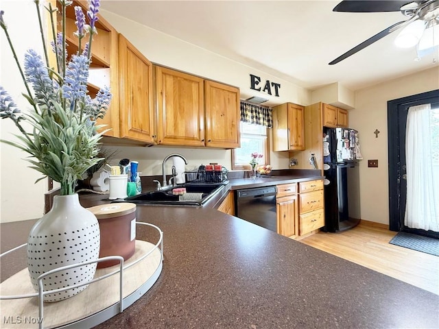 3522 Oakdale Ave, Lorain, OH 44055 - kitchen with black appliances, dark countertops, a ceiling fan, and light wood-style flooring