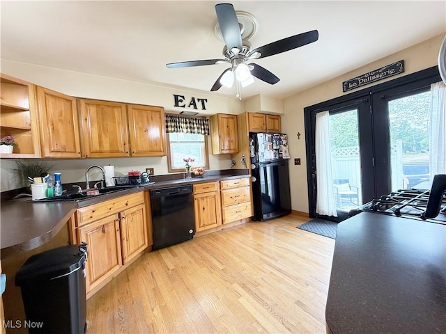3522 Oakdale Ave, Lorain, OH 44055 - kitchen with black appliances, dark countertops, light wood-type flooring, and ceiling fan