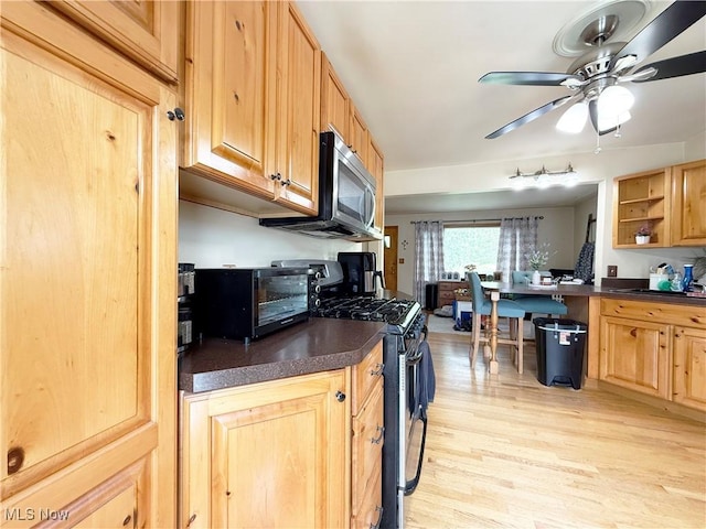 3522 Oakdale Ave, Lorain, OH 44055 - kitchen featuring appliances with stainless steel finishes, dark countertops, light wood finished floors, and ceiling fan