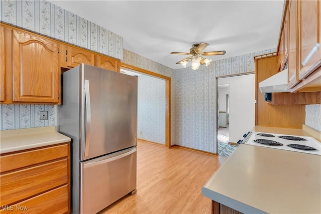 93 Olalla Ave, Tallmadge, OH 44278 - kitchen with freestanding refrigerator, wallpapered walls, a ceiling fan, light countertops, and light wood-type flooring