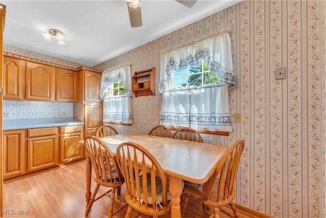 93 Olalla Ave, Tallmadge, OH 44278 - dining space with wallpapered walls, light wood-style flooring, and ceiling fan
