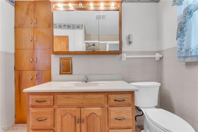 93 Olalla Ave, Tallmadge, OH 44278 - bathroom with tile walls, vanity, and a wainscoted wall
