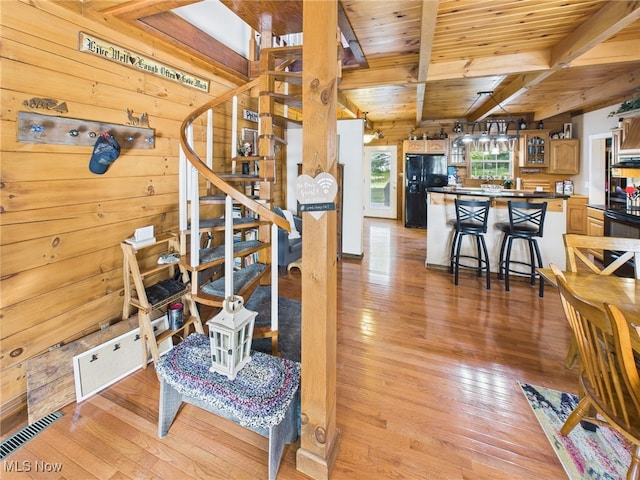 9246 State Route 555, Cutler, OH 45724 - living area with a wooden ceiling with exposed beams, light wood-type flooring, stairs, and wood walls