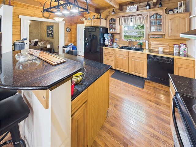9246 State Route 555, Cutler, OH 45724 - kitchen featuring black appliances, wooden walls, light wood finished floors, a wood ceiling with exposed beams, and glass insert cabinets