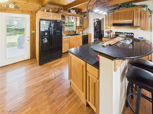 9246 State Route 555, Cutler, OH 45724 - kitchen featuring black appliances, light wood finished floors, a breakfast bar area, glass insert cabinets, and extractor fan