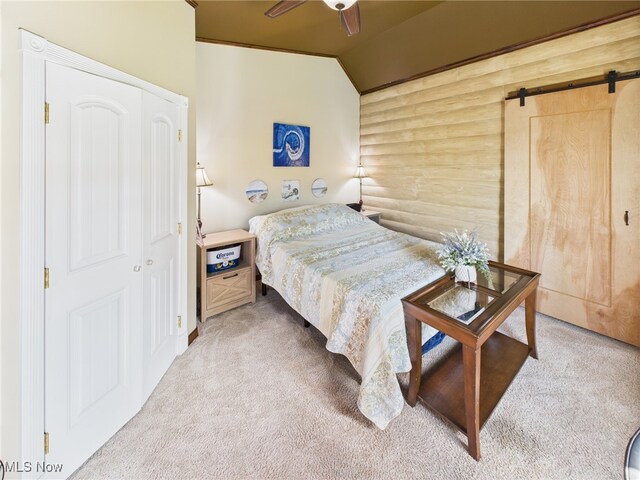 9246 State Route 555, Cutler, OH 45724 - carpeted bedroom with a barn door, rustic walls, lofted ceiling, and ceiling fan