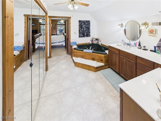 9246 State Route 555, Cutler, OH 45724 - ensuite bathroom with ceiling fan, a garden tub, vanity, vaulted ceiling, and tile patterned floors