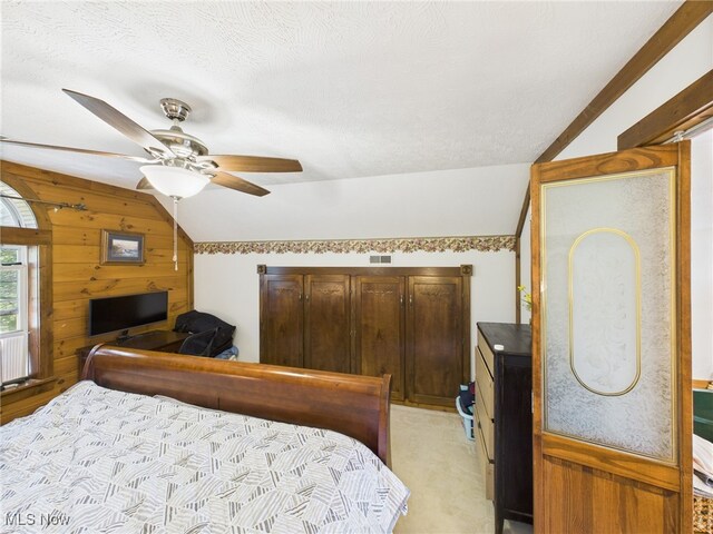 9246 State Route 555, Cutler, OH 45724 - bedroom featuring vaulted ceiling, wooden walls, light colored carpet, a textured ceiling, and a ceiling fan