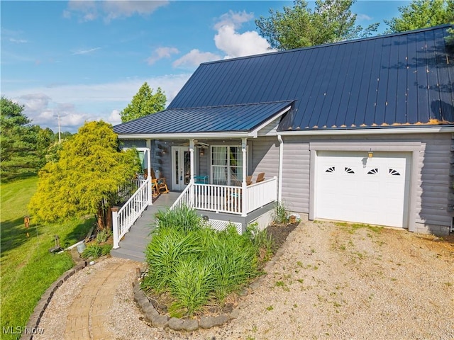 9246 State Route 555, Cutler, OH 45724 - view of front of home with a porch, driveway, a standing seam roof, a metal roof, and french doors