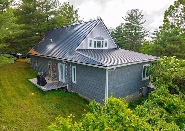 9246 State Route 555, Cutler, OH 45724 - back of house featuring a deck, a standing seam roof, a lawn, a metal roof, and view of wooded area
