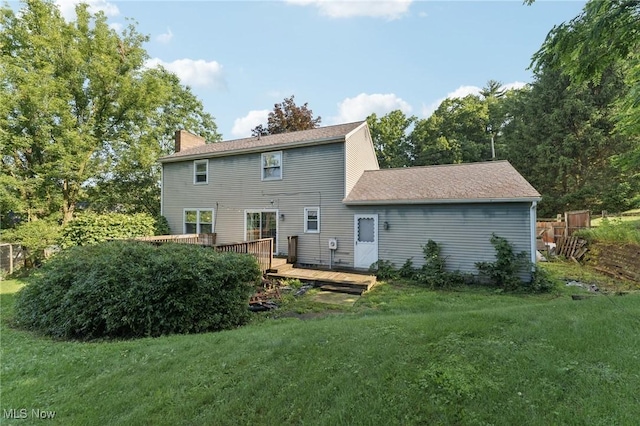 3594 Heckman St NW, Uniontown, OH 44685 - rear view of property featuring a deck, a yard, and a chimney
