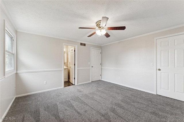 3594 Heckman St NW, Uniontown, OH 44685 - unfurnished bedroom featuring carpet floors, crown molding, a ceiling fan, ensuite bathroom, and a textured ceiling