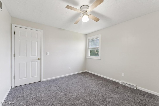 3594 Heckman St NW, Uniontown, OH 44685 - unfurnished room featuring carpet floors, ceiling fan, and a textured ceiling