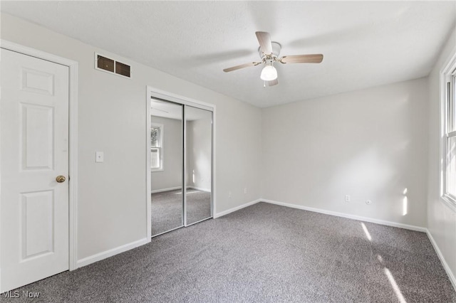 3594 Heckman St NW, Uniontown, OH 44685 - unfurnished bedroom featuring carpet, a closet, and a ceiling fan