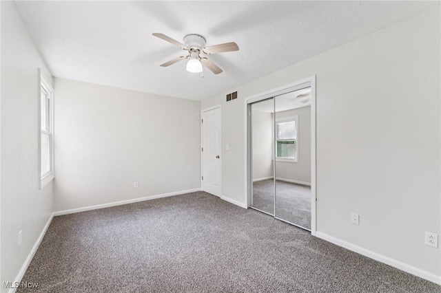 3594 Heckman St NW, Uniontown, OH 44685 - unfurnished bedroom with carpet floors, a closet, and a ceiling fan