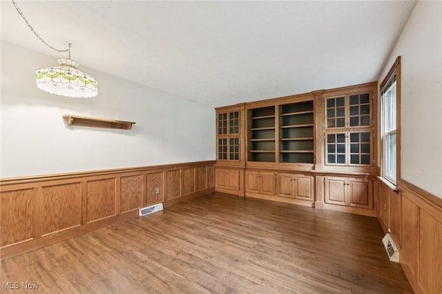 3594 Heckman St NW, Uniontown, OH 44685 - empty room featuring a wainscoted wall and wood finished floors