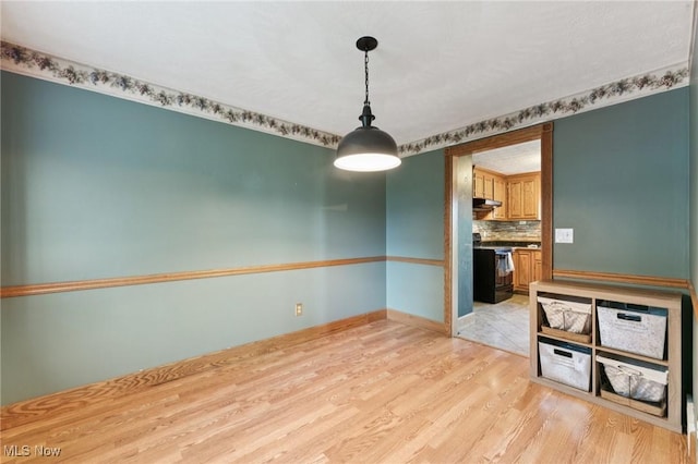 3594 Heckman St NW, Uniontown, OH 44685 - empty room featuring light wood finished floors and baseboards