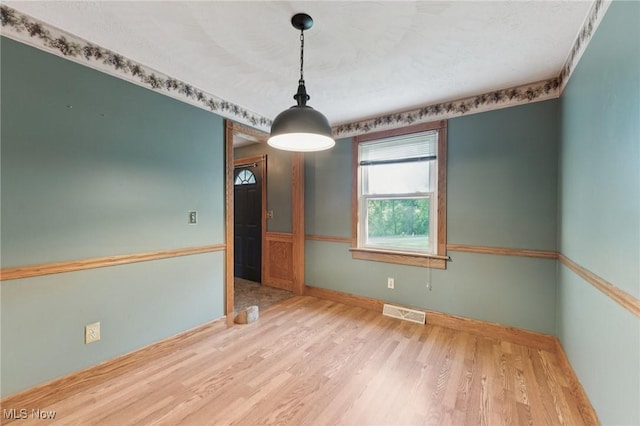 3594 Heckman St NW, Uniontown, OH 44685 - empty room featuring wood finished floors and baseboards