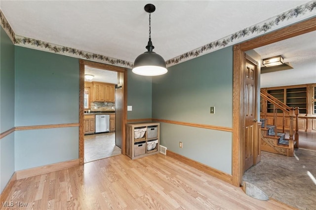 3594 Heckman St NW, Uniontown, OH 44685 - spare room with light wood-style flooring and stairs