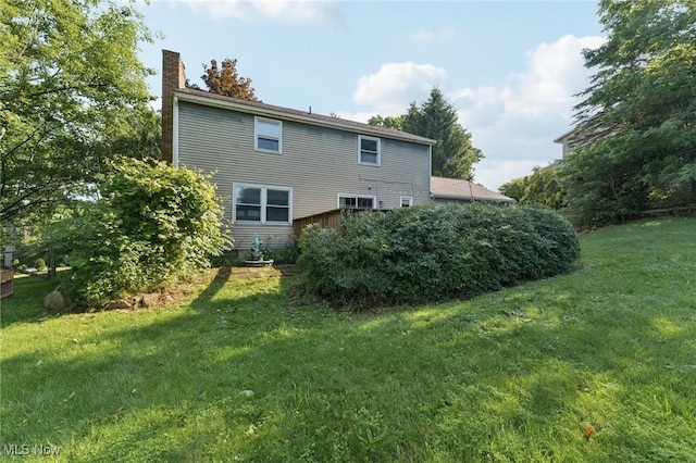3594 Heckman St NW, Uniontown, OH 44685 - back of property featuring a chimney and a yard