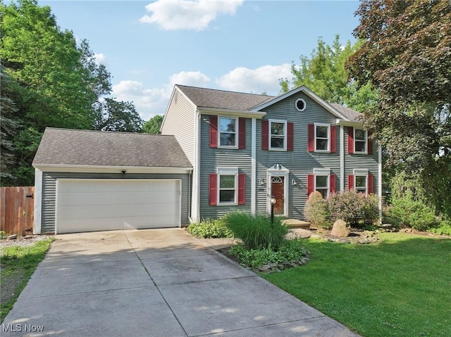 3594 Heckman St NW, Uniontown, OH 44685 - colonial house featuring an attached garage, concrete driveway, and a shingled roof