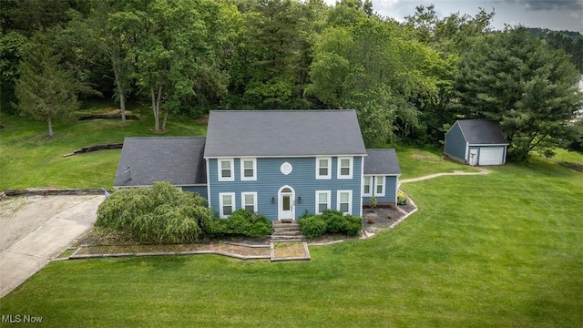 1310 Oxbow Rd, Belpre, OH 45714 - colonial home featuring a garage, an outbuilding, and a front lawn