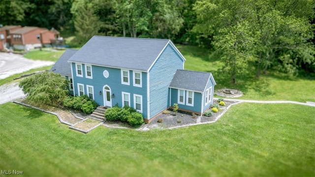 1310 Oxbow Rd, Belpre, OH 45714 - colonial inspired home with a front lawn, a shingled roof, and view of scattered trees