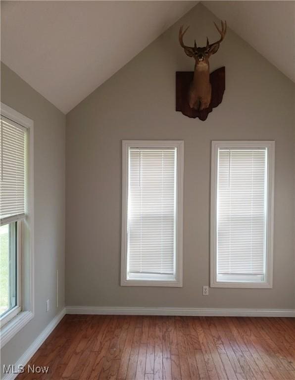 1310 Oxbow Rd, Belpre, OH 45714 - spare room featuring vaulted ceiling and hardwood / wood-style floors
