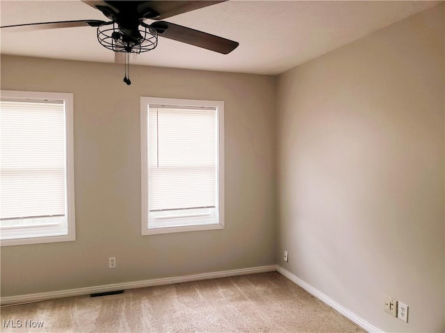 1310 Oxbow Rd, Belpre, OH 45714 - empty room featuring a ceiling fan, light colored carpet, and healthy amount of natural light
