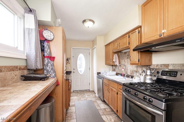 35109 Elm Rd, Grafton, OH 44044 - kitchen featuring stainless steel appliances, under cabinet range hood, tile countertops, and decorative backsplash