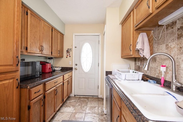 35109 Elm Rd, Grafton, OH 44044 - kitchen with black microwave, stainless steel dishwasher, tasteful backsplash, and brown cabinetry