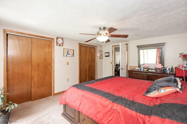 35109 Elm Rd, Grafton, OH 44044 - bedroom with two closets, light colored carpet, and a ceiling fan