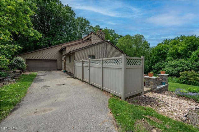 3355 Waterford Rd, New Waterford, OH 44445 - view of home's exterior featuring a chimney and a garage