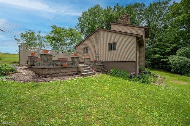 3355 Waterford Rd, New Waterford, OH 44445 - rear view of house featuring a yard and a chimney
