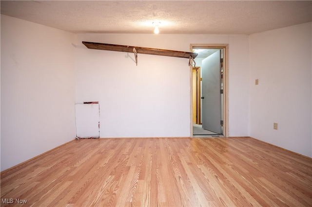 3355 Waterford Rd, New Waterford, OH 44445 - unfurnished room with light wood-type flooring and a textured ceiling