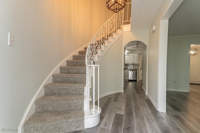 3 Meadowlawn Dr Unit 13, Mentor, OH 44060 - stairs with a chandelier, arched walkways, and wood finished floors