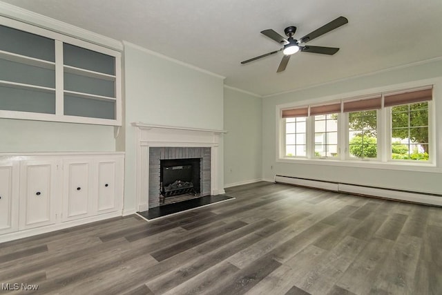 3 Meadowlawn Dr Unit 13, Mentor, OH 44060 - unfurnished living room featuring a baseboard heating unit, crown molding, a ceiling fan, a fireplace, and wood finished floors