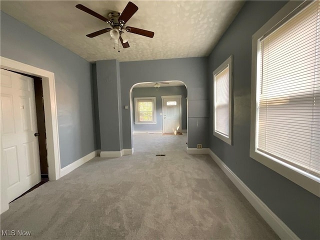 4313 Warner Rd, Cleveland, OH 44105 - unfurnished room featuring carpet, ceiling fan, and arched walkways