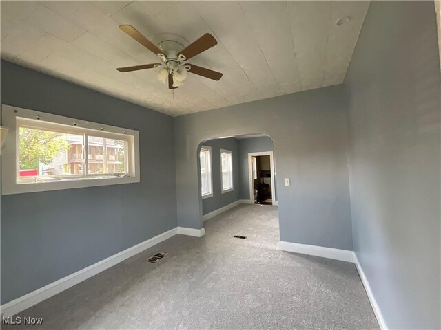4313 Warner Rd, Cleveland, OH 44105 - unfurnished room with arched walkways, healthy amount of natural light, a ceiling fan, and carpet floors