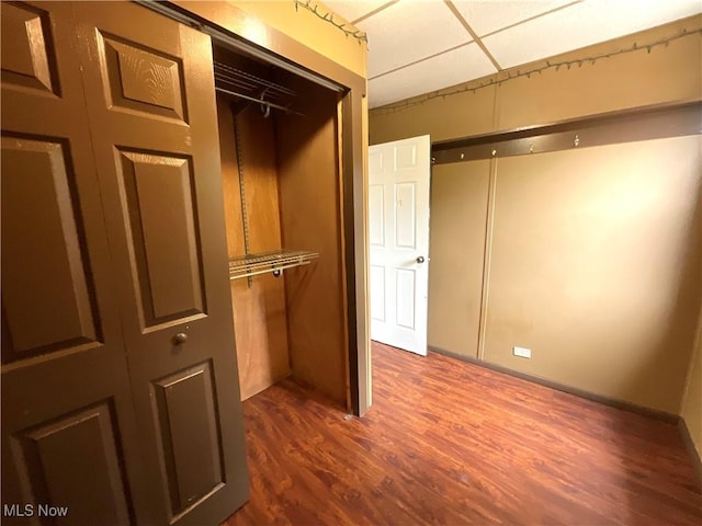 4313 Warner Rd, Cleveland, OH 44105 - unfurnished bedroom with a paneled ceiling, dark wood-type flooring, and a closet