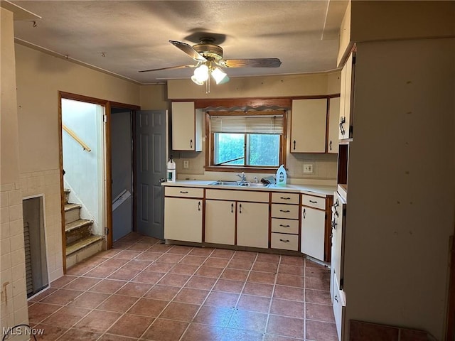 816 W 22nd St, Lorain, OH 44052 - kitchen with a ceiling fan, light countertops, white cabinets, and tile patterned floors