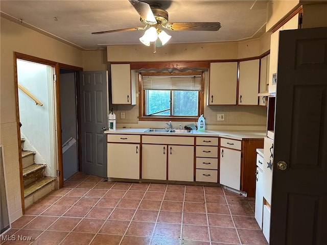 816 W 22nd St, Lorain, OH 44052 - kitchen featuring light countertops, a ceiling fan, decorative backsplash, and tile patterned flooring