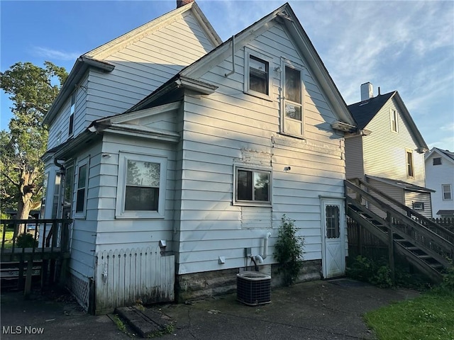 816 W 22nd St, Lorain, OH 44052 - rear view of house featuring stairway and a chimney