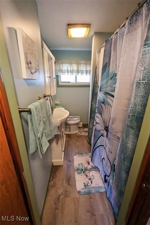 6323 Olive Ave, North Ridgeville, OH 44039 - bathroom featuring wood finished floors and a shower with shower curtain